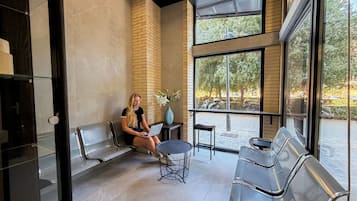 Un interno moderno con posti a sedere, un portatile e vista sull'esterno.