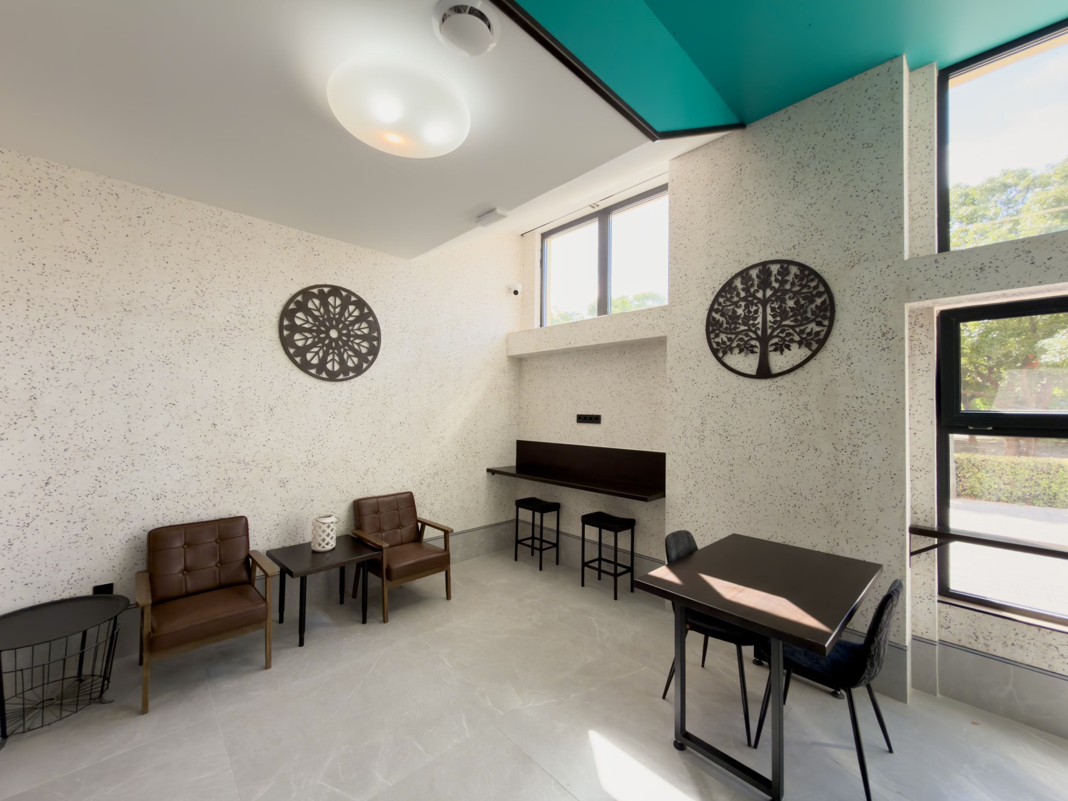 A modern interior with a dining area, seating, and a kitchen.