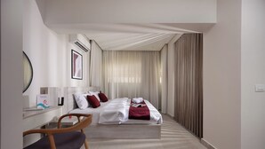 A modern hotel room with a bed, a desk, and a chair. - 88 by spacey (cairo)