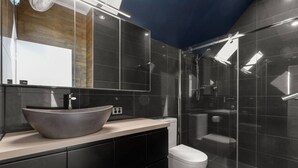 A modern bathroom with a large vessel sink, a toilet, and a glass-enclosed shower area. - Private 2BR Villa | Minutes from Brisbane CBD (Spring Hill)