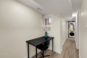 Dedicated workspace for remote productivity, conveniently located near the in-suite laundry facilities.