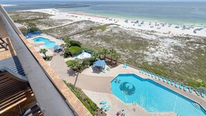 A resort with multiple swimming pools, beach access, and a view of the ocean. - Gorgeous Beachfront 1BR at Phoenix East (Orange Beach)