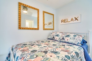 A bedroom with a bed, two mirrors, and a 'RELAX' sign. - 3-unit Group Getaway! Steps to Indian Rocks Beach (Indian Rocks Beach)