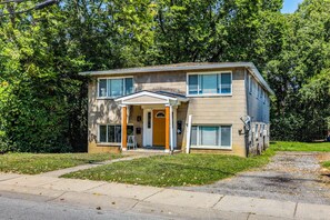 A two-story residential building with a front porch and a garage. - Cincinnati-area Condo: Near Shops & Dining (Cincinnati)