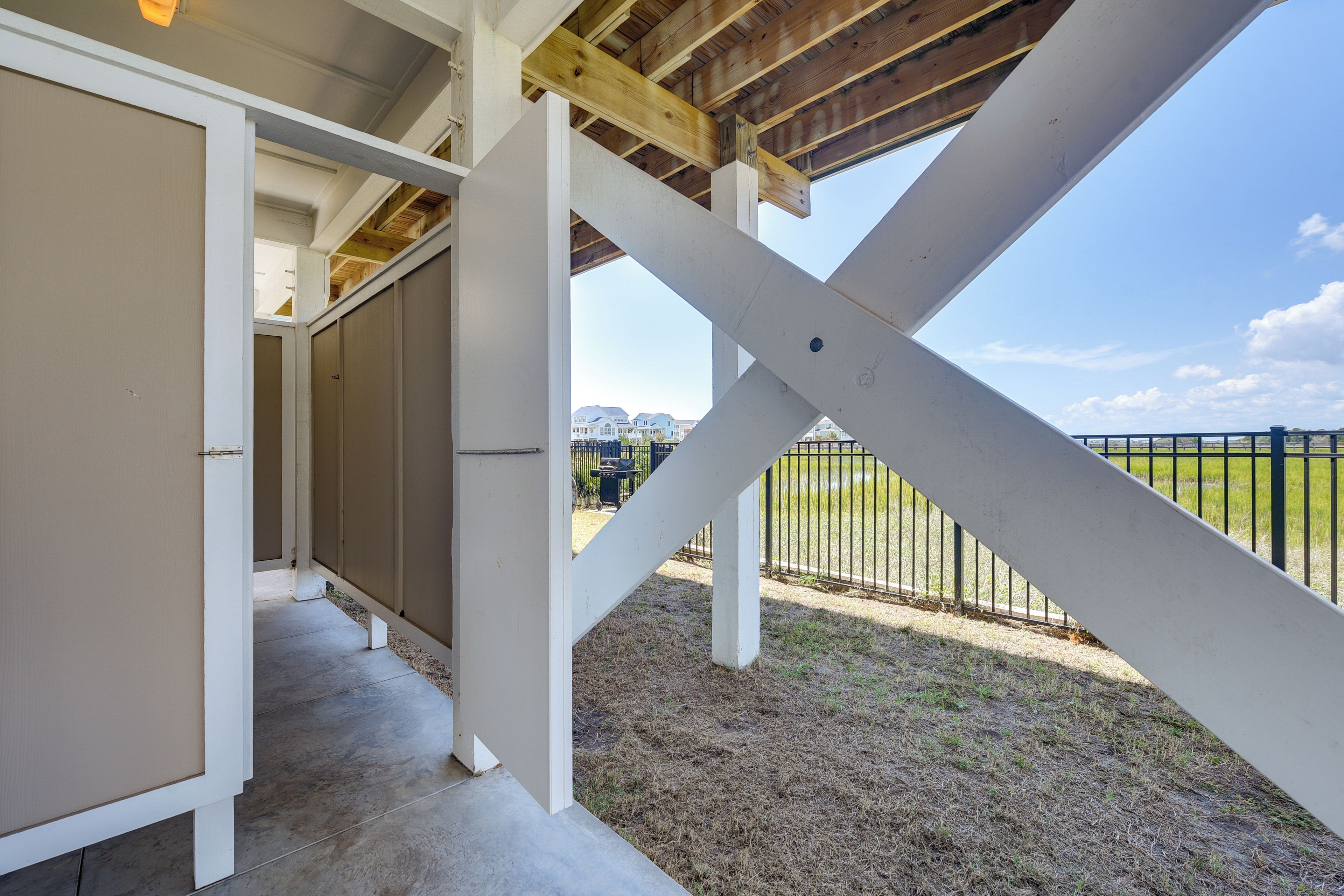 A covered outdoor area with a view of a residential neighborhood.