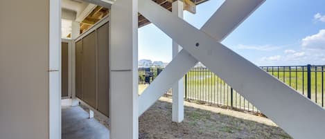 A covered outdoor area with a view of a residential neighborhood.