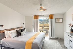 A bedroom with a bed, a ceiling fan, a window with curtains, and a view of the outdoors. - Mtn-view Colorado Escape 11 Mi to Ouray (Ridgway)
