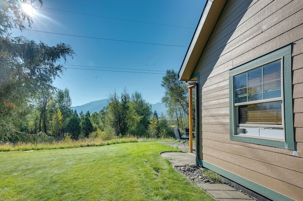 A house with a wooden exterior, a clear sky, and a mountain in the background. - Walk to Yellowstone River! Emigrant Home w/ Patio (Emigrant)