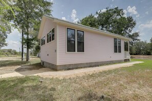 A single-story mobile home with a flat roof, a front porch, and a small attached garage.