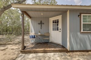 A small, single-story building with a porch, a door, and a window. - Boutique Retreat Minutes From Round Top! (Fayetteville)