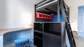 Un letto a castello con una scrivania, una sedia, una scala e un mobile contenitore rosso.