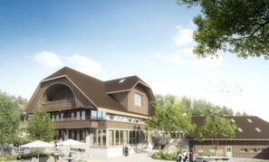 A multi-story building with a modern architectural design, featuring balconies and large windows. - Appenberg Hoteldorf, Seminare & Events (Mirchel)