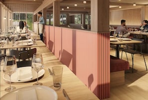 A modern restaurant with wooden tables and chairs, a service counter, and a view of the outdoors. - Appenberg Hoteldorf, Seminare & Events (Mirchel)