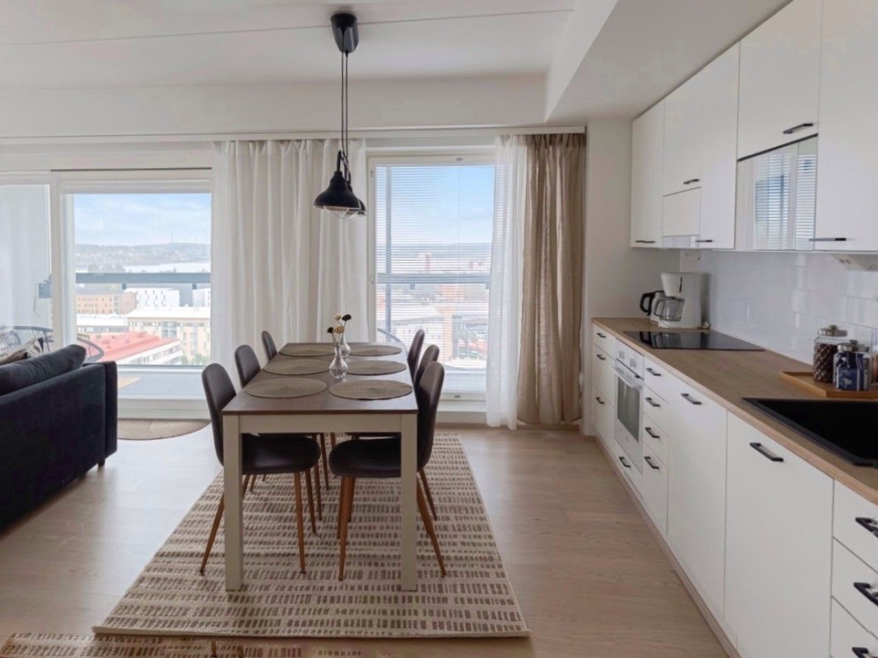 A modern, fully equipped open kitchen containing absolutely everything you need for cooking and dining. Amenities include a stove, oven, refrigerator, freezer, microwave, coffee maker, electric kettle, toaster, and a complete set of tableware.