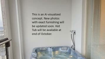 A hot tub in a corner of a room with a window and a wall-mounted text.