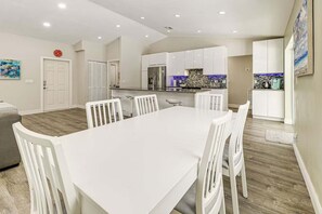 A modern kitchen with white cabinets, a stainless steel refrigerator, and a blue backsplash. - Beach in 5 Mins - Private Saltwater Pool BBQ (Deerfield Beach)