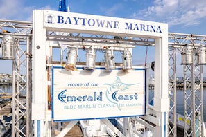 A sign for Baytowne Marina advertising the Emerald Coast Blue Marlin Classic at Sandestin. - Golf Course View Villa With Luxury 6 Seater Golf Cart Steps to Beach Pool Tram Just Across From Entry (Miramar Beach)