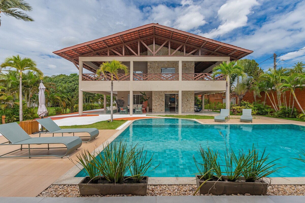 A two-story building with a pool in front.