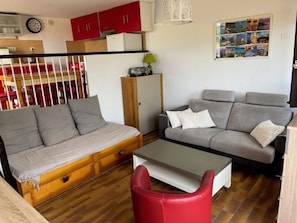 A living room with a sofa, a red chair, a coffee table, and a cabinet. - Bright house in Porticcio for 6 people (Grosseto-Prugna)