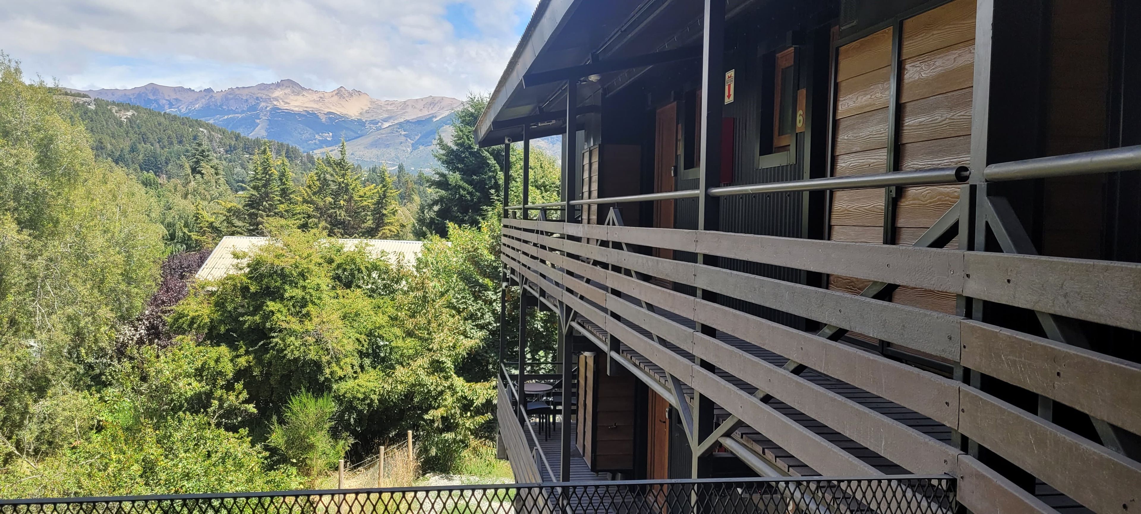 A balcony with a view of a mountainous landscape.