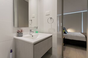 Ein modernes Badezimmer mit Waschbecken, Spiegel und Toilette.