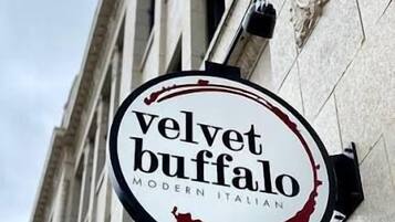 A sign for 'Velvet Buffalo Modern Italian' restaurant.