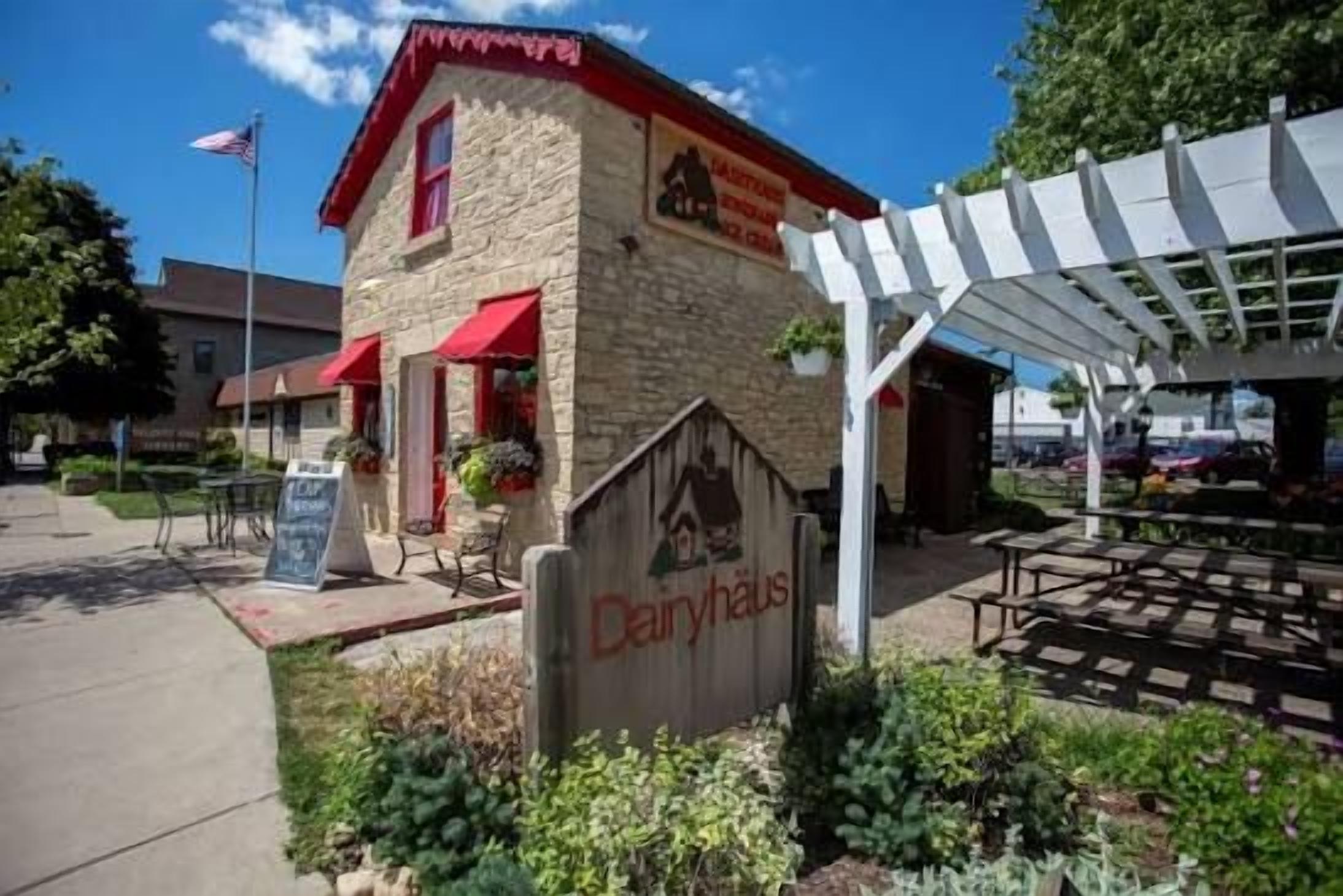 A building with a stone facade, red awnings, and a sign that reads 'Dairyhaus.'