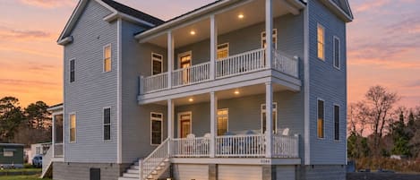 A two-story house with a front porch, a staircase, and a number '8046' on the front.