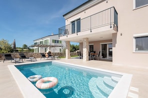 A modern two-story house with a swimming pool, outdoor seating, and a covered patio area. - Villa With Modern Living in Farini (Visnjan)