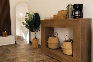 A wooden console table with woven baskets, a coffee maker, and a potted plant. - King Suite - Casa Corazon Zen in Barra De Potosi with pool, 3 min. walk to beach (Barra de Potosí)