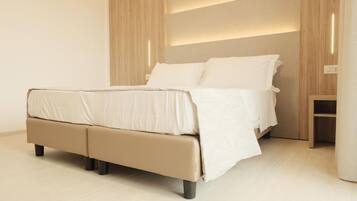 Un dormitorio moderno con cama, cabecero de madera y mesita de noche.