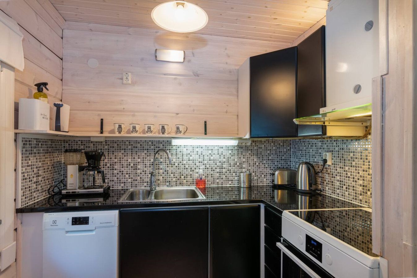 A modern kitchen with wooden cabinets, a tiled backsplash, and stainless steel appliances.
