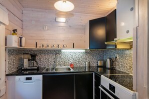 A modern kitchen with wooden cabinets, a tiled backsplash, and stainless steel appliances.