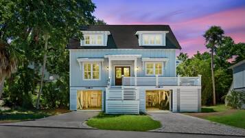 A two-story house with a front porch, a garage, and a driveway.