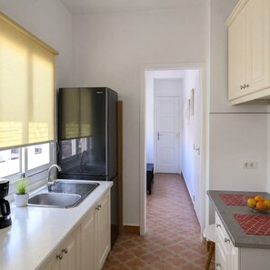 A compact kitchen with a stainless steel refrigerator, a sink, and a countertop with a coffee maker. - VV Vacation Health 1 (Santa Cruz de Tenerife)