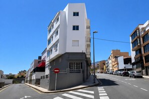 A multi-story urban street with a no-entry sign, parked cars, and buildings with balconies. - VV Vacation Health 1 (Santa Cruz de Tenerife)