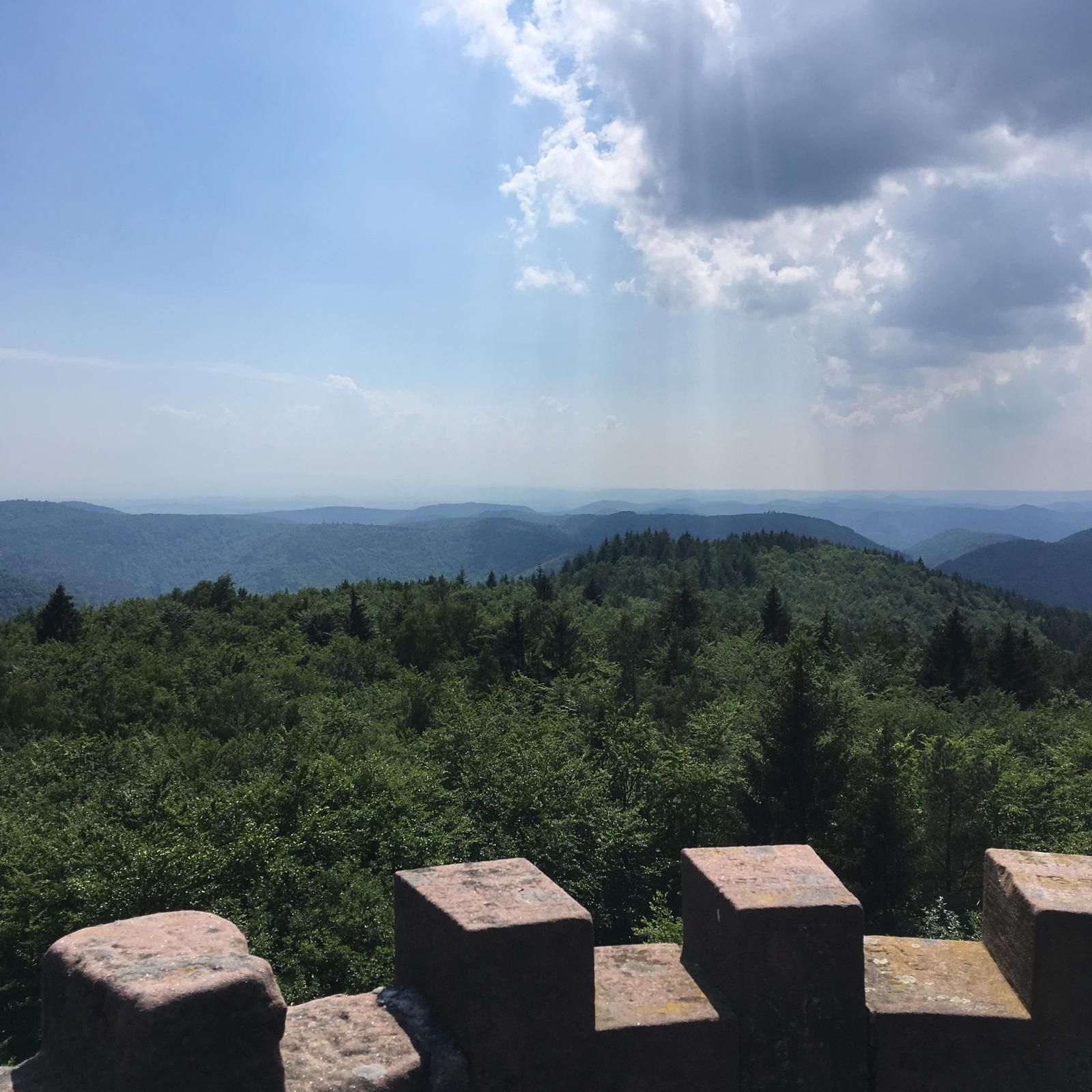 A mountainous landscape with a clear sky and distant hills.