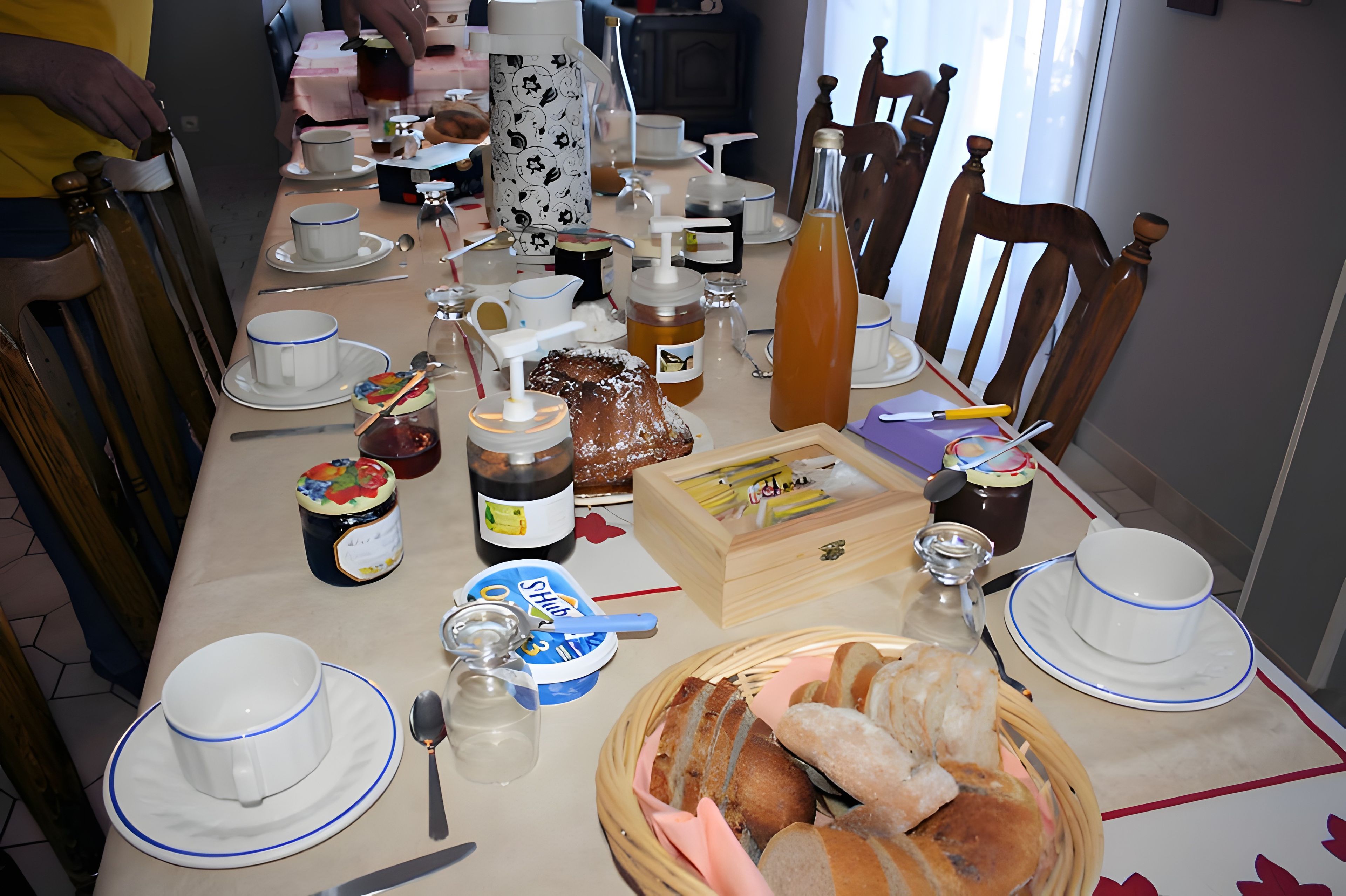 A dining table set with various dishes, utensils, and condiments.