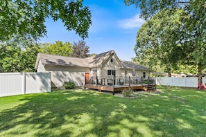 A single-story house with a fenced backyard, a covered porch, and a small deck. - New Listing! Fenced Yard | Near Golf & Saugatuck (Saugatuck)