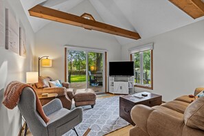 A living room with a TV, sofas, a coffee table, and a fireplace. - New Listing! Fenced Yard | Near Golf & Saugatuck (Saugatuck)