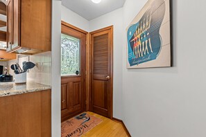 A kitchen with wooden cabinets, a granite countertop, and a window with decorative glass. - New Listing! Fenced Yard | Near Golf & Saugatuck (Saugatuck)