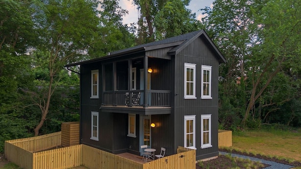 A two-story house with a balcony, a fenced deck, and a small garden area. - Downtown Centric, Tucked Away, Fenced, PetsOK (Durham)