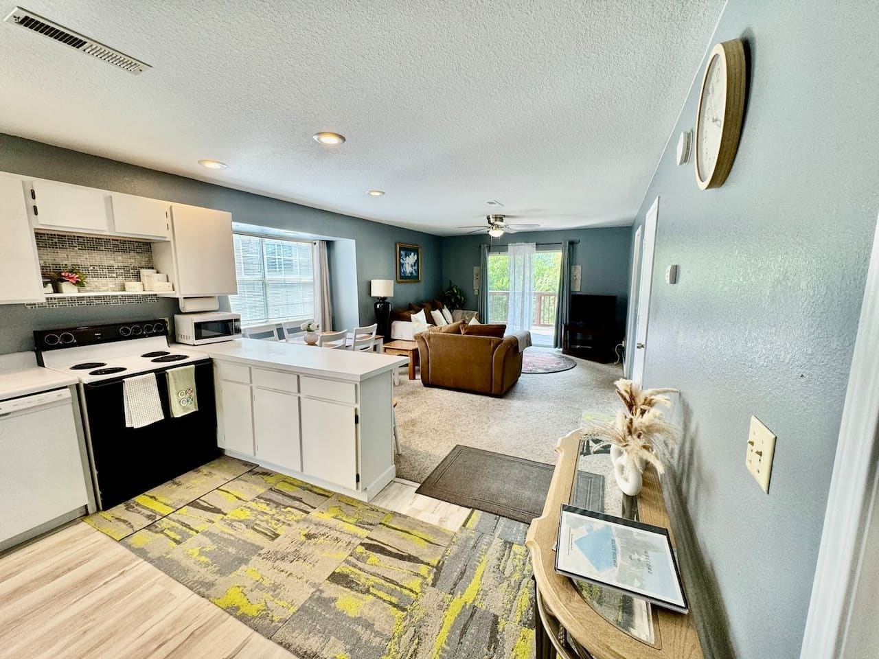 A compact living space with a kitchenette, a dining area, and a seating area.
