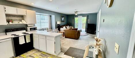 A compact living space with a kitchenette, a dining area, and a seating area.