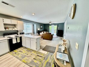 A compact living space with a kitchenette, a dining area, and a seating area. - SDC Ground Level Condo (Branson)