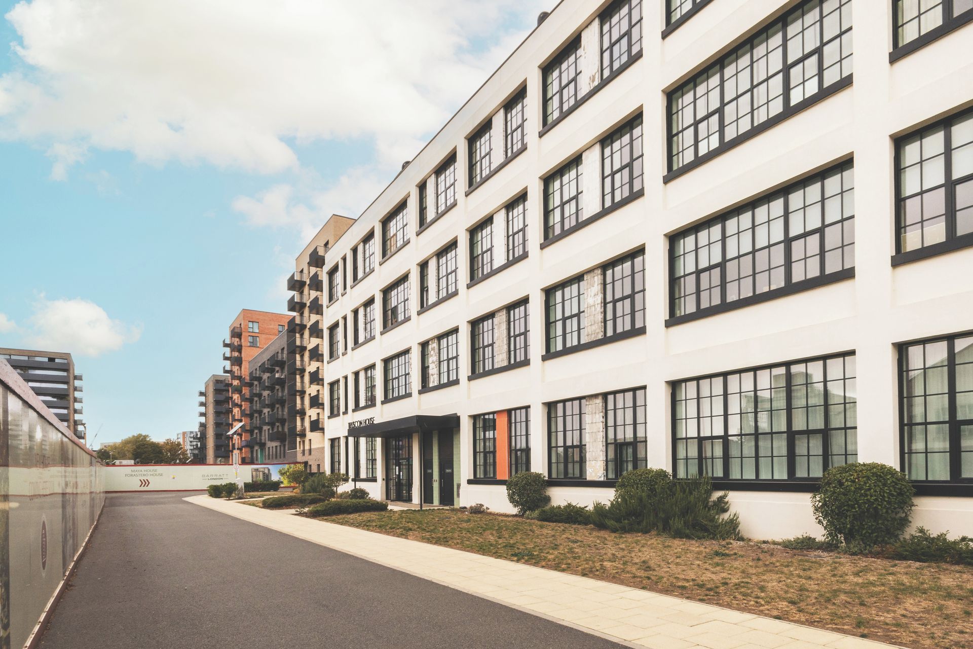 A modern building with multiple floors, large windows, and a clean, well-maintained exterior.