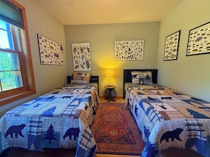 A room with two beds, a window, and wall-mounted wildlife posters. - Nellie's Lodge-Outdoor Sauna, close to X-C Ski Trails (Ironwood)
