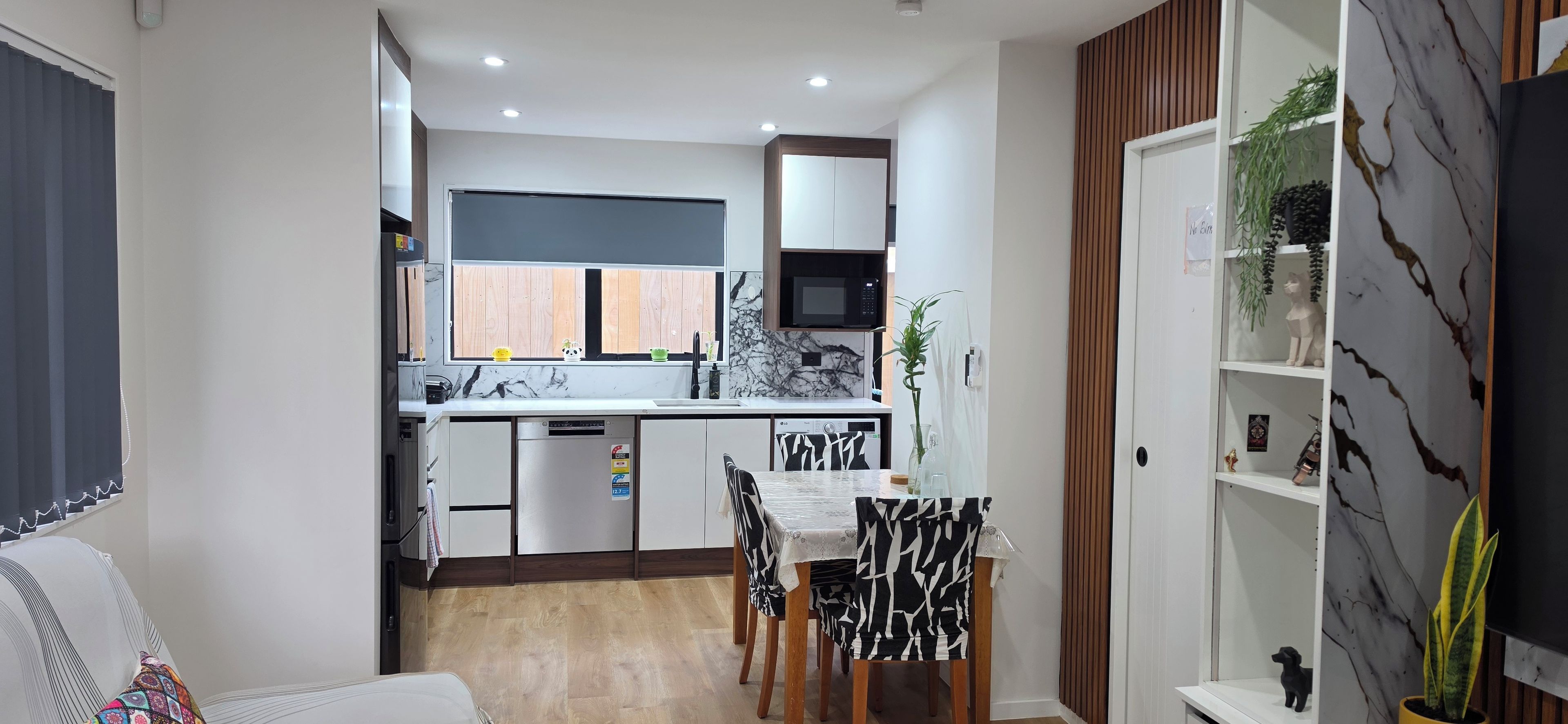 A compact kitchen with a dining area, a microwave, and a small refrigerator.