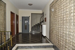 A hallway with a marble floor, a staircase, and a radiator. - Ifigenia and Evrdiki Apts near Acropolis (Athina)