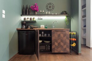 A compact kitchen with a built-in dishwasher, a sink, and a herringbone-patterned cabinet. - Ifigenia and Evrdiki Apts near Acropolis (Athina)